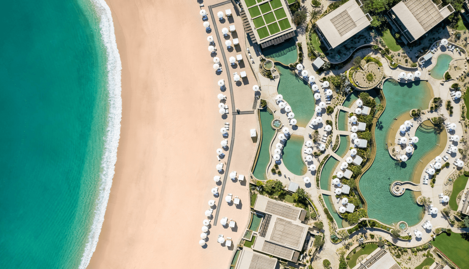 Montage Chileno Bay aerial view — resort pool system, beach, and turquoise Sea of Cortez from above