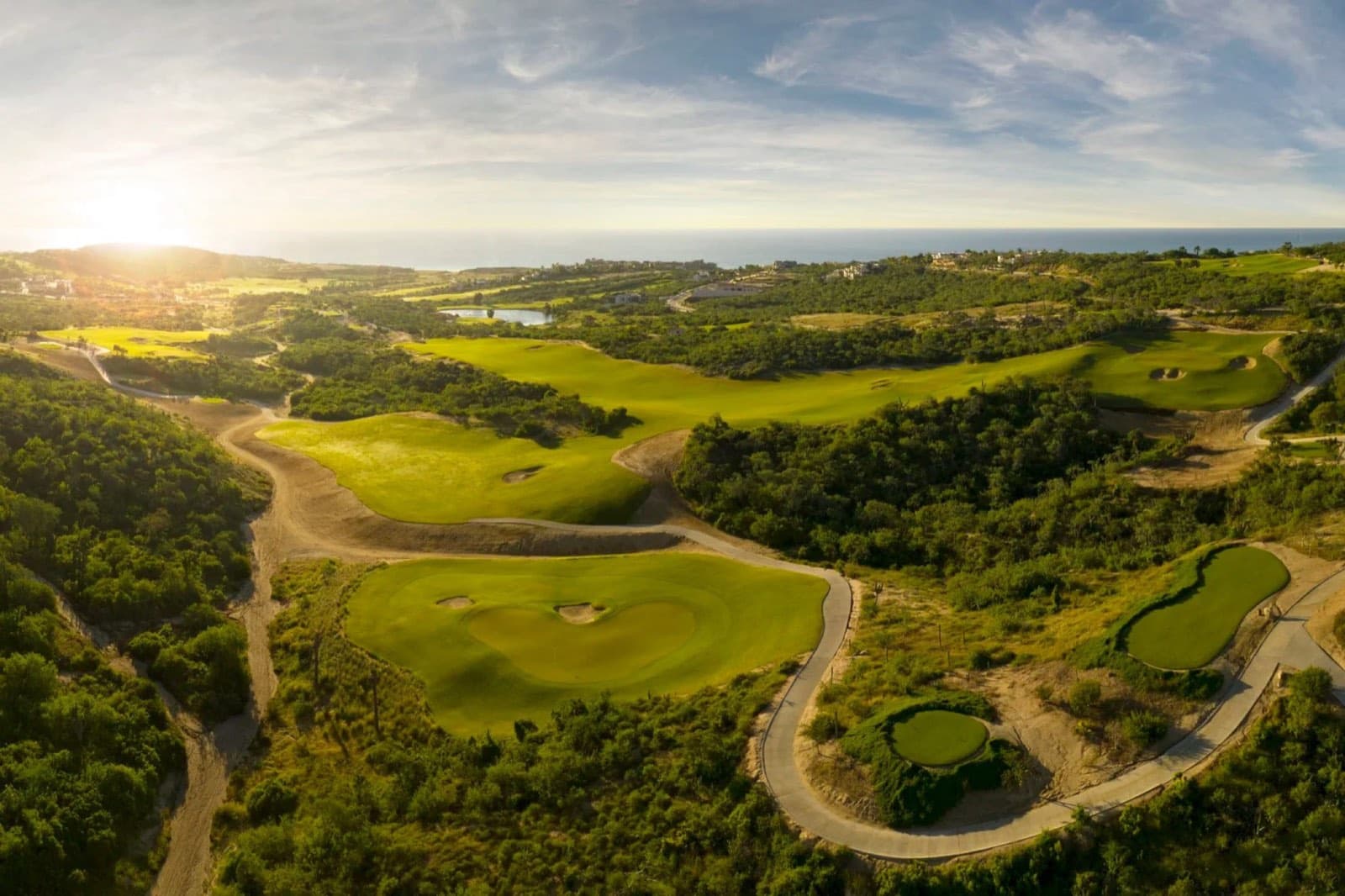 Aerial view of a Jack Nicklaus-designed hole winding through desert at Puerto Los Cabos