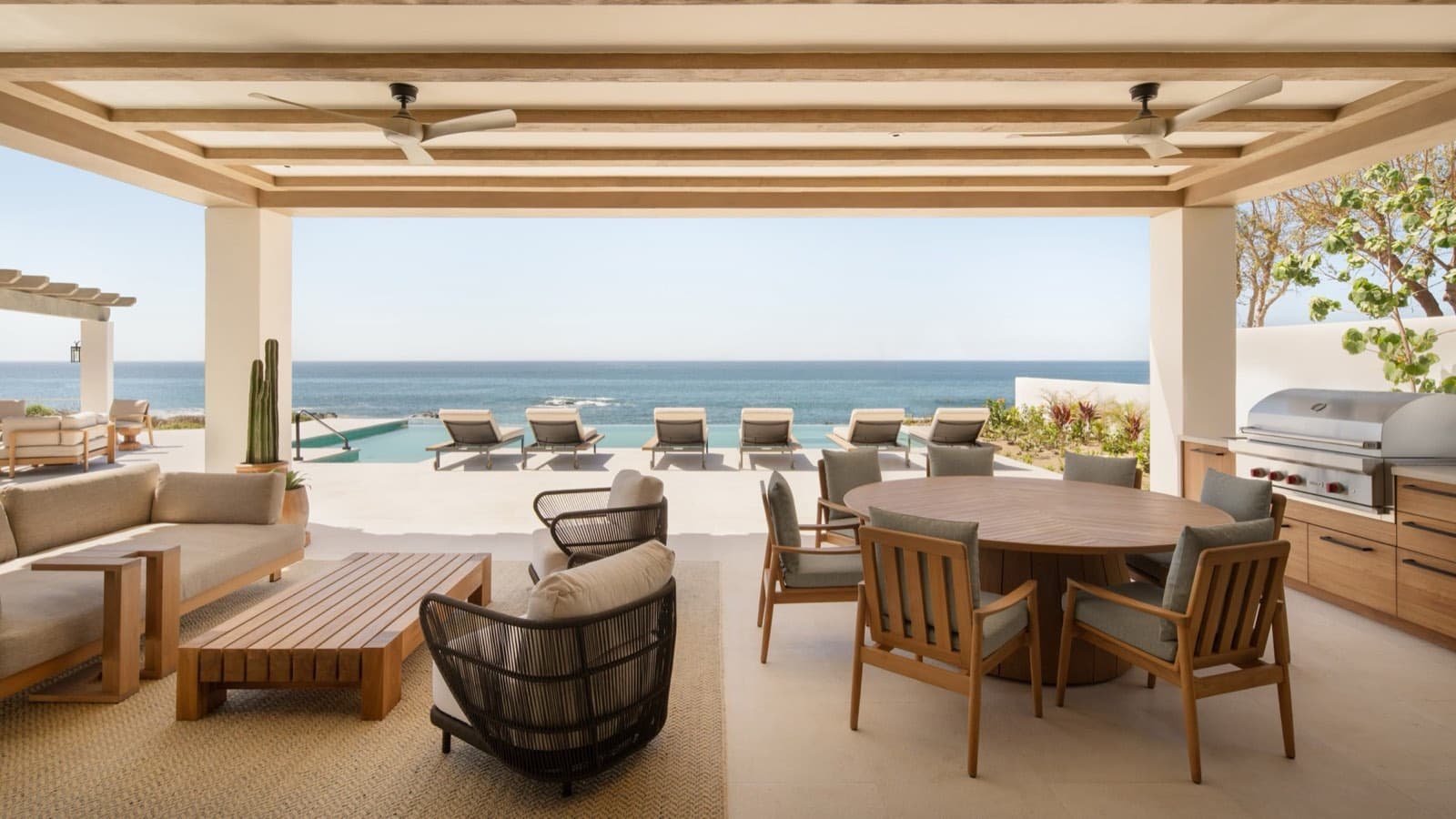 Covered outdoor living and dining terrace overlooking the ocean at Cabo del Sol