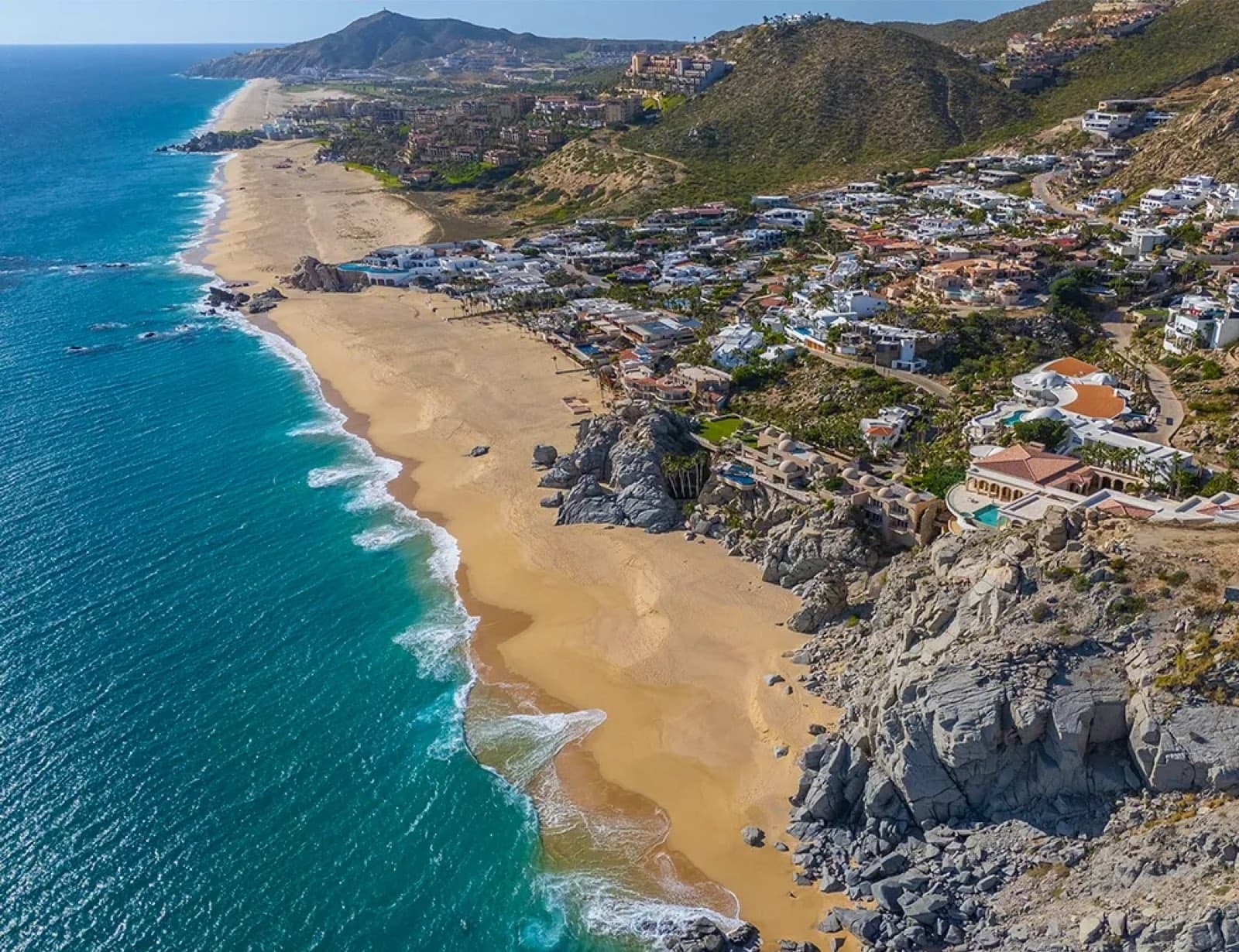 Aerial view of the long Pacific beach and rocky point below Pedregal, Cabo San Lucas