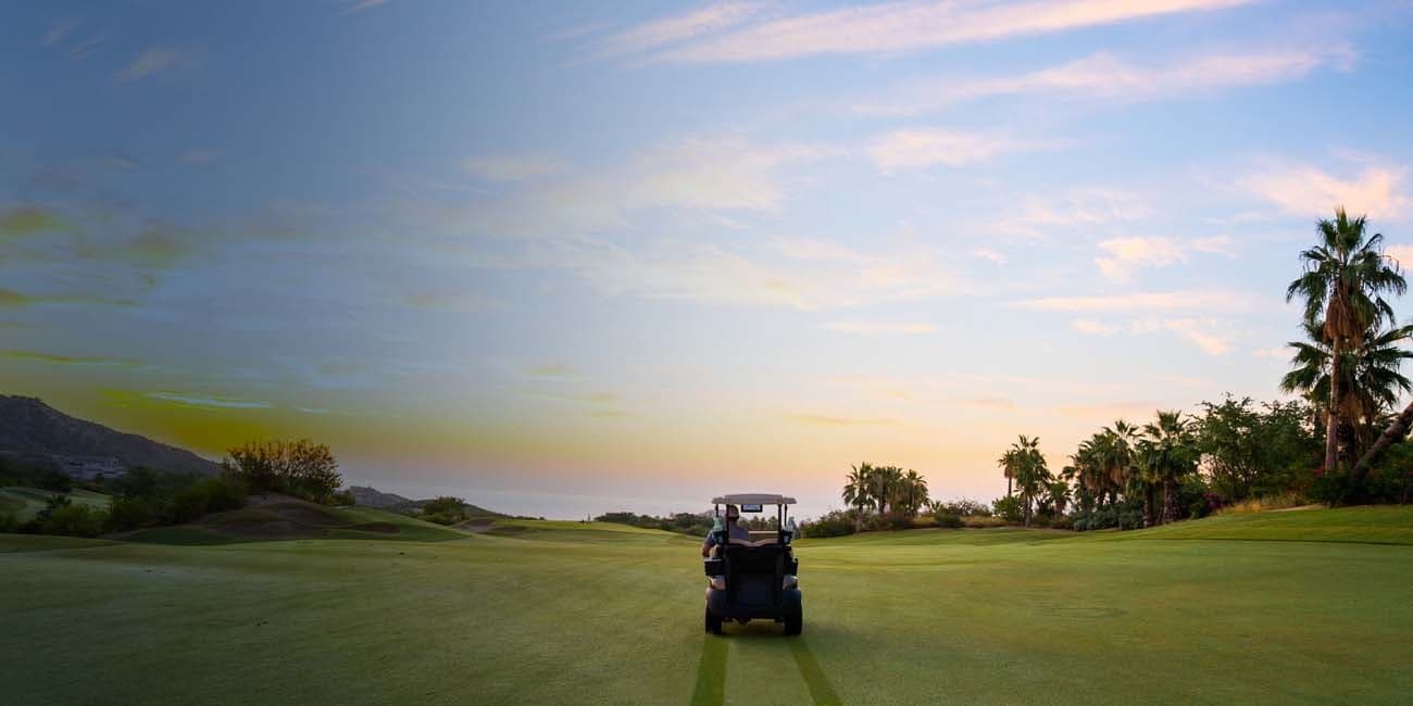 Golf cart on a Querencia fairway at sunset